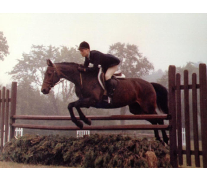 Ann Hogan in her younger years, jumping in a horse show ring