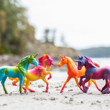 Breyer Stablemates Unicorn Swirl Gift Set four models on beach background