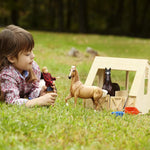 Breyer Traditional Freedom Wood Stable with child playing in a field