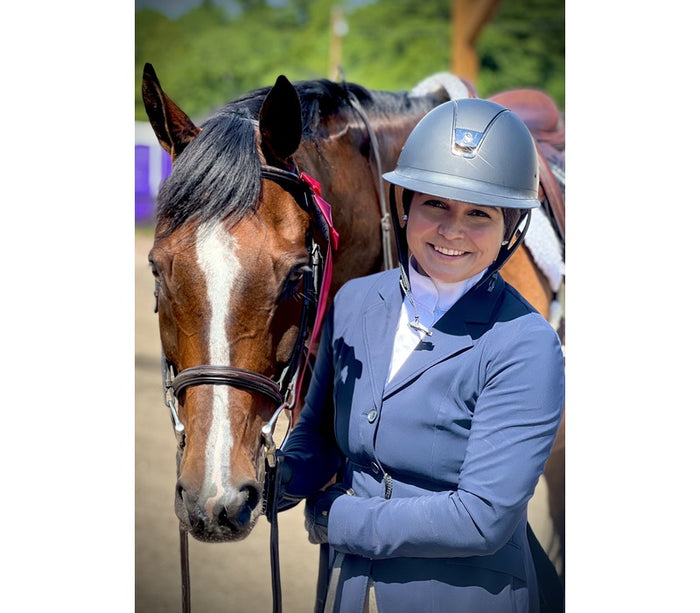Brianna and her horse Nick at the show grounds, with a second place ribbon from their most recent class.