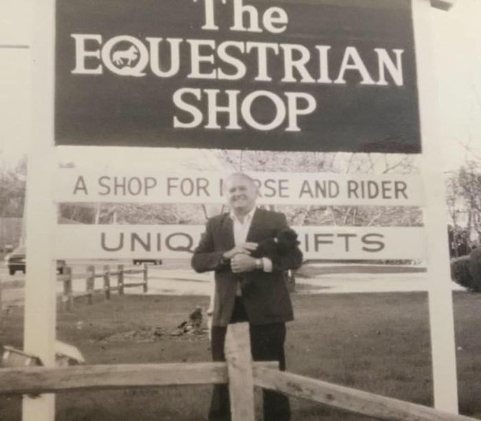 Paul Proulx Holding his dog Rugby in front of the equestrian shop sign in the early years of the North Andover store.