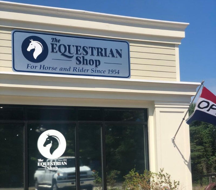 The Rowley Location of The Equestrian shop with the sign out front and the open flag. 